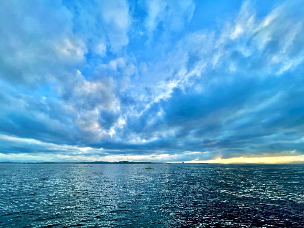 Sunrise over open sea from early morning dive boat departure Malapascua